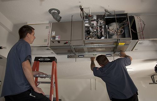 Sean McCutcheon service technicians installing a unit.